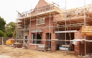 Brick-house-under-construction-with-scaffolding-representing-Public-Housing-UK