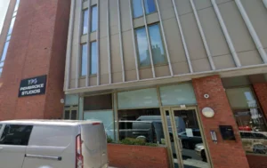 Exterior-of-Pembroke-Studios-building-with-a-van-parked-outside-keyword-Supported-Living-Flats