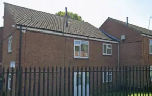 Exterior-view-of-a-brick-building-with-windows-and-black-metal-fence-identified-as-Sketchley-Court-properties-Sketchley-Court-Conversion