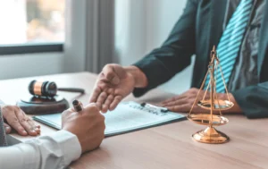Person-signing-legal-document-with-gavel-scales-of-justice-and-lawyer-present-symbolizing-the-role-of-accountability-and-oversight