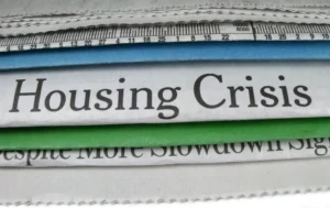 stack-of-newspapers-with-headline-housing-crisis-visible-supported-housing-crisis