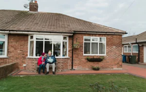 supported-living-accommodation-bungalow-with-two-people-sitting-outside
