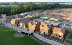 A-developing-community-with-completed-homes-in-the-foreground-showcasing-how-a-Property-Rent-Guarantee-can-attract-more-landlords