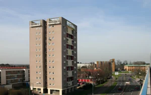 A-tan-colored-Block-of-Flats-surrounded-by-greenery
