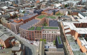 An-aerial-view-of-a-new-flats-plan,-showcasing-a-large-development-with-multiple-buildings-and-green-rooftops