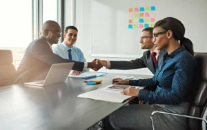 Business-professionals-collaborating-and-shaking-hands-on-housing-solutions