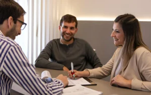 People-discussing-documents-symbolizing-a-partnership-agreement-in-the-context-of-guaranteed-rent-agreements-and-property-investments.