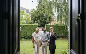 Real-estate-agent-showing-a-property-to-potential-tenants-related-to-HMO-Management