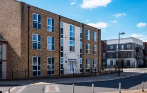 Modern-building-exterior-with-the-Supported-Living-Rent-Guide-message