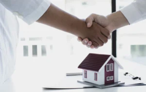 hmo-landlords-hands-shaking-with-mini-house-model