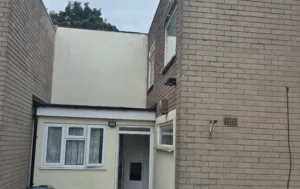 Two-people-smiling-and-holding-keys-outside-a-6-bed-HMO-property-in-Selly-Oak