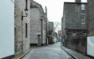 Narrow-cobblestone-street-between-brick-buildings–What-Is-a-Residential-Care-Home