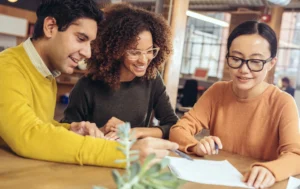 Group-of-people-discussing-and-signing-documents-guaranteed-rent-for-landlords