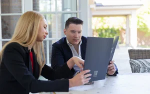 Two-professionals-discussing-documents-about-guaranteed-rent-for-overseas-property-investors