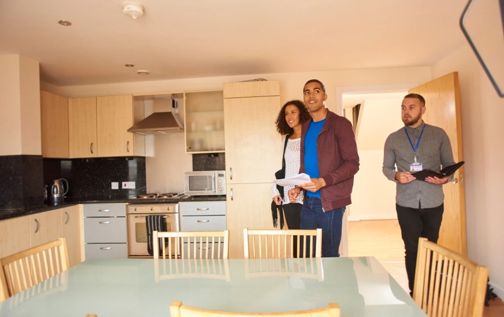 A-couple-is-viewing-a-kitchen-with-an-estate-agent