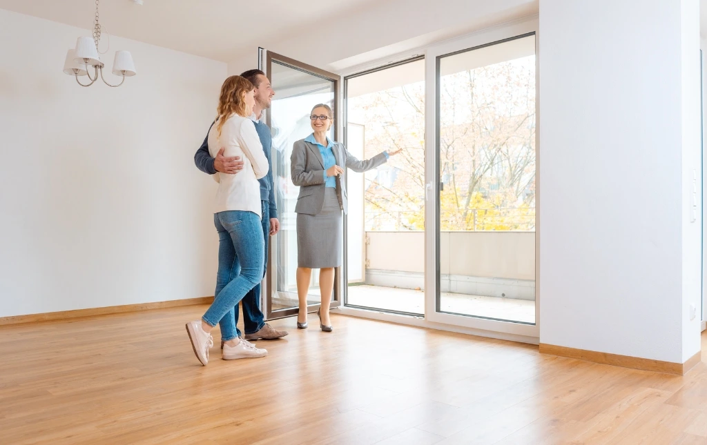 A-couple-tours-a-bright-modern-apartment-with-an-estate-agent-showcasing-spacious-living-as-they-explore-Moving-Beyond-Traditional-Letting