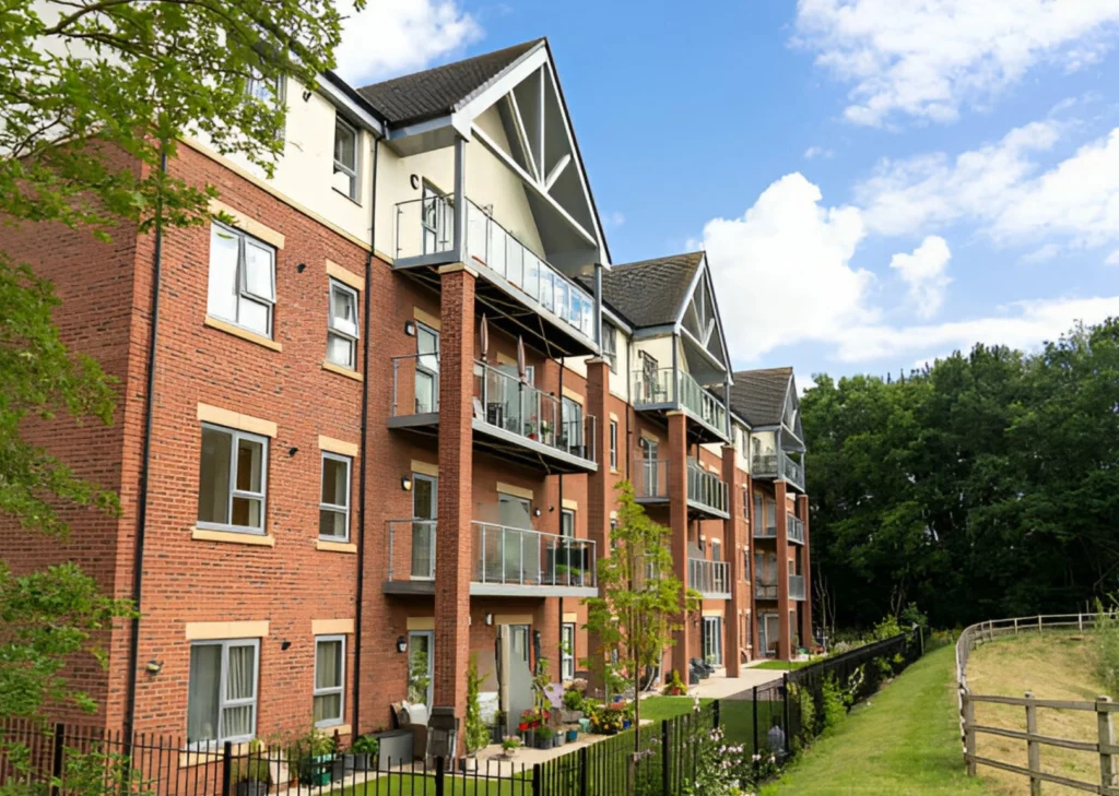 Modern-residential-building-with-balconies-and-green-surroundings
