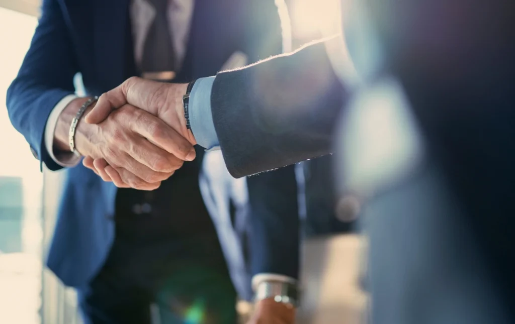 Two-business-professionals-shaking-hands-with-sunlight-symbolizing-Landlord-updates-Prem-property